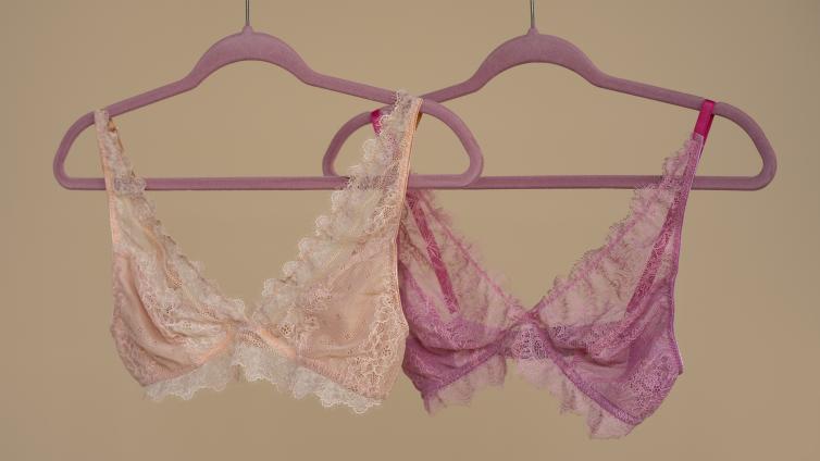 Two bras each on a hanger