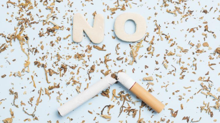 The word "No" laying next to a cigarette and its contents 